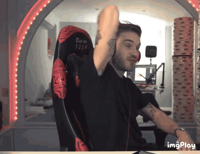 a man is sitting in a chair that says clutch 100a on it