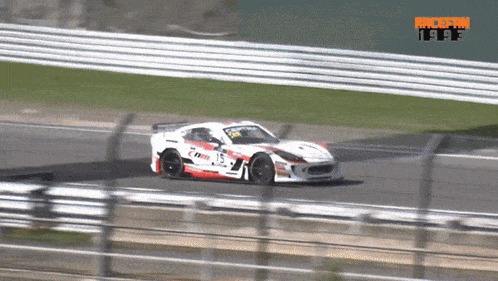 a race car is driving down a track with the word tuff on the bottom left