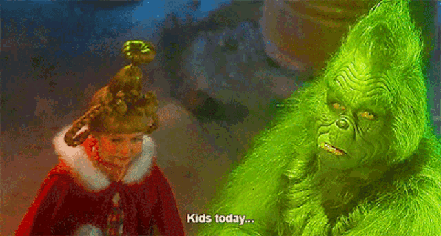 the grinch is talking to a little girl who is wearing a red cape and a crown .