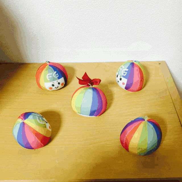 a bunch of colorful balls on a wooden table
