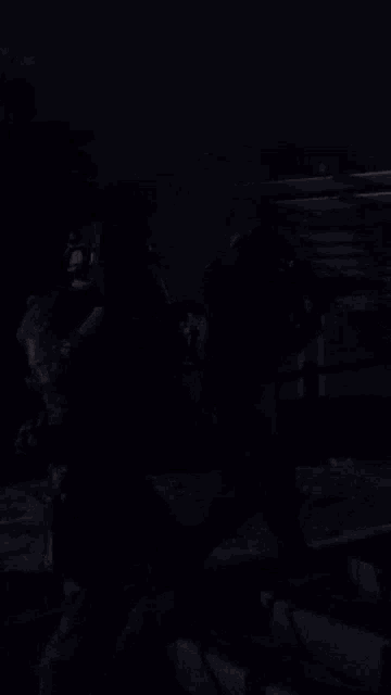 two soldiers are fighting in the dark and one has a gun on his back
