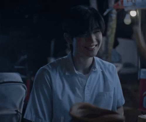 a young man is smiling in front of a sign that says 24 ct