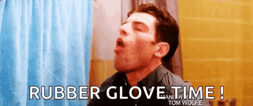 a man is wearing a rubber glove in the bathroom .