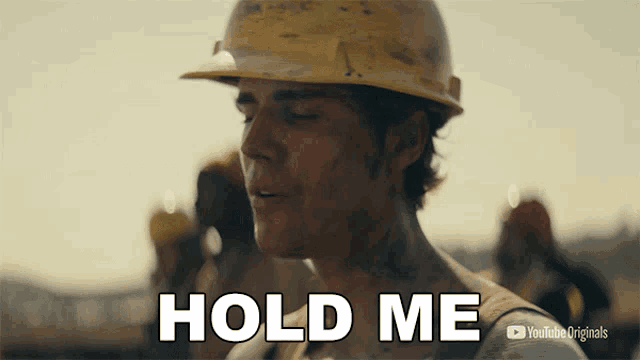 a man wearing a hard hat says hold me in a youtube originals ad