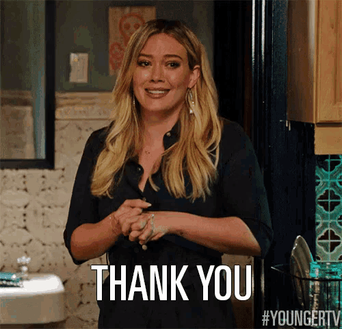 a woman in a black shirt is smiling and says thank you