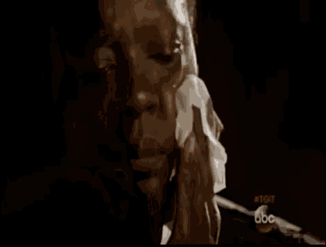 a close up of a man 's face with blood coming out of his mouth and mouthpiece .