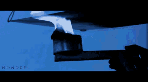 a blue background with a flame and the word monokel