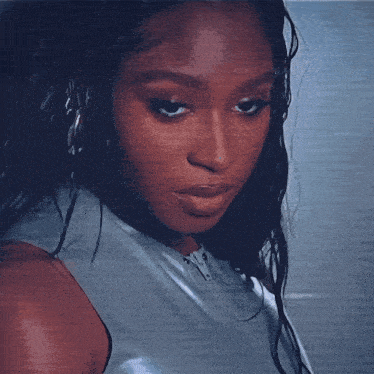 a close up of a woman 's face with a serious expression