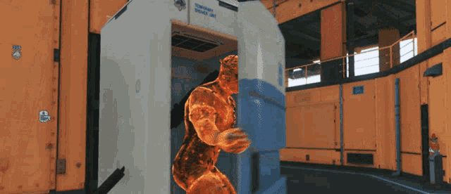 a man is standing in a room with a sign that says ' thermal scanner unit ' on it