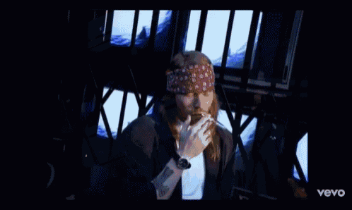 a man in a bandana is smoking a cigarette