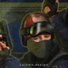 a man wearing a helmet and goggles is holding a gun with the words corewn.design written on the bottom