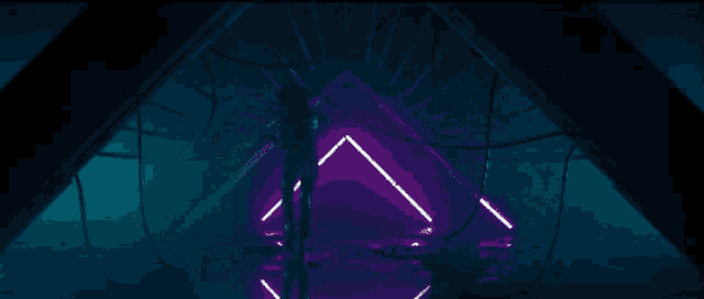 a woman in a bathing suit is standing in a tunnel with blue lights behind her