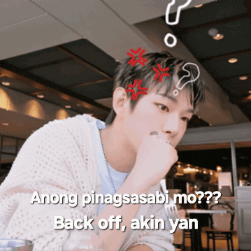 a man sitting at a table with a question mark above his head and the words " anong pinagsasabi mo back off akin yan "