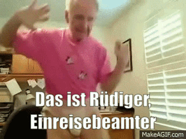 a man in a pink shirt is dancing in front of a window with the words das ist rudiger einreisebeamter on the bottom