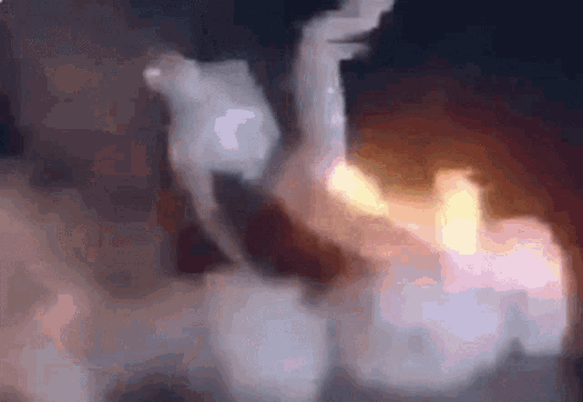 a close up of a person holding a candle in a dark room