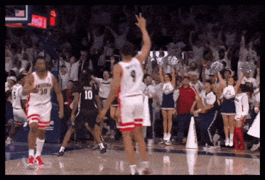 a basketball player with the number 9 on his jersey is jumping in the air