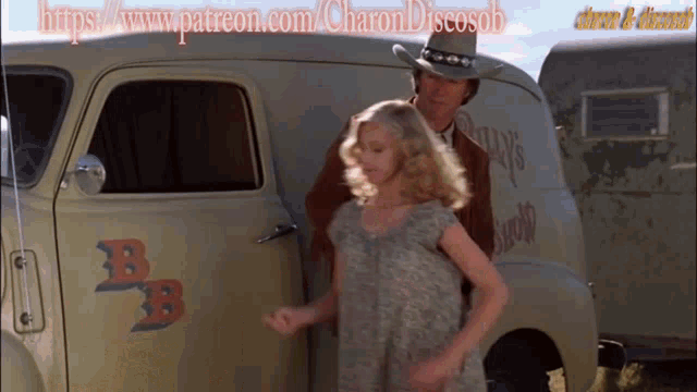 a little girl is standing next to a man in a cowboy hat in front of a van that says pump 's
