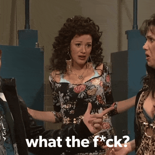 a woman in a floral dress is pointing at another woman and the words what the f * ck are on the screen