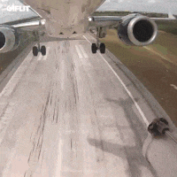 a plane is taking off from a runway with the word coiffut on the bottom right