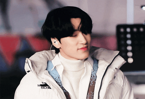 a man wearing a white jacket with the north face on it
