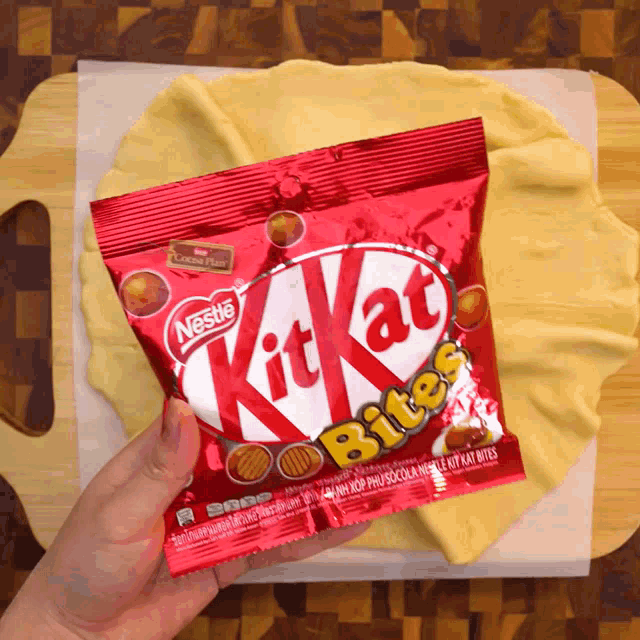 a person holding a bag of kitkat bites