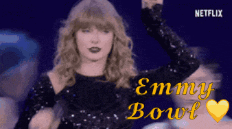 a woman in a sequined dress is dancing with the words emmy bowl written on the bottom