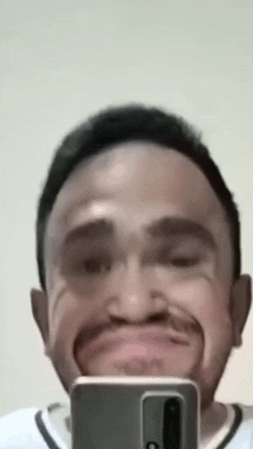 a man is taking a selfie with his cell phone .