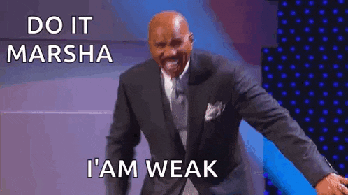 a man in a suit and tie is standing on a stage and laughing .