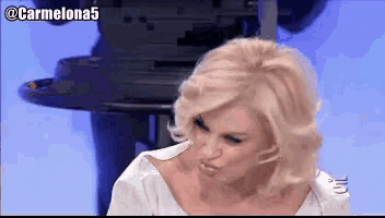 a woman making a funny face with the hashtag @ carmelona5 above her
