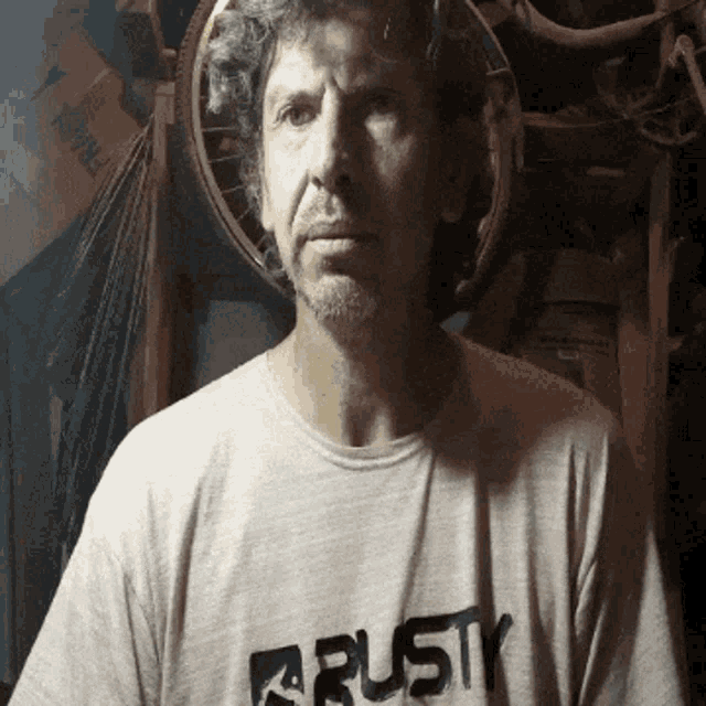 a man wearing a t-shirt that says rusty on it