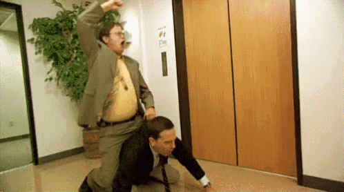 a man in a suit and tie is riding another man in an elevator .