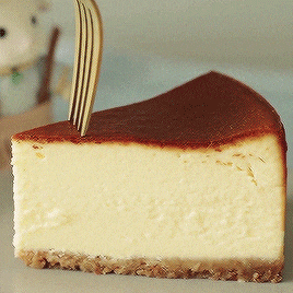 a slice of cheesecake with a fork sticking out of it on a plate