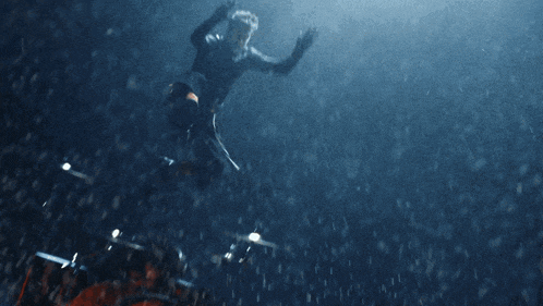 a man in a suit is jumping in the water