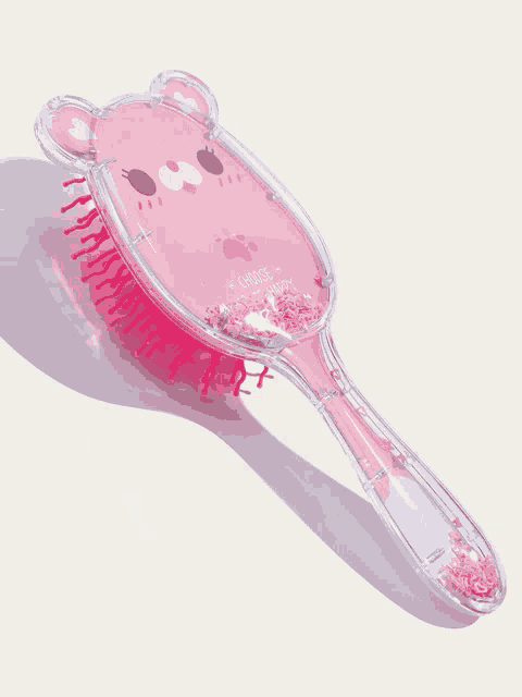 a pink hair brush with the words " choose " on the front