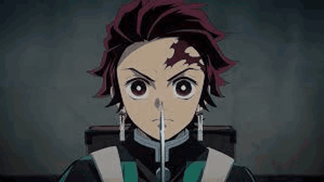 a close up of a person holding a sword in their mouth in a dark room .