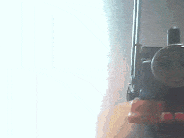 a person is holding a toy train that is smiling