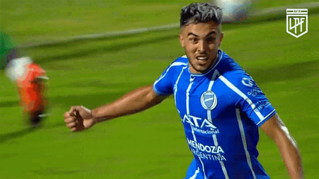 a soccer player in a blue and white jersey with the letters lpfl on the bottom right