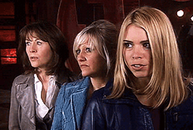 three women are standing next to each other with one wearing a leather jacket