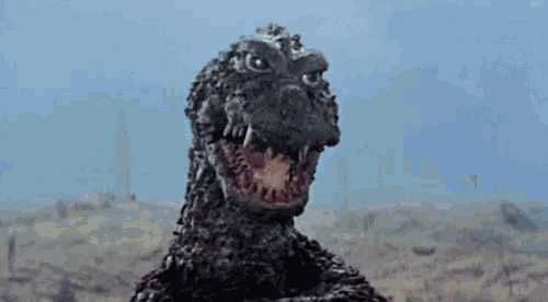 a close up of a monster with its mouth open and teeth .