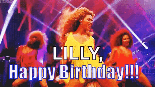 a group of women are dancing on a stage with the words `` lilly , happy birthday !! ''