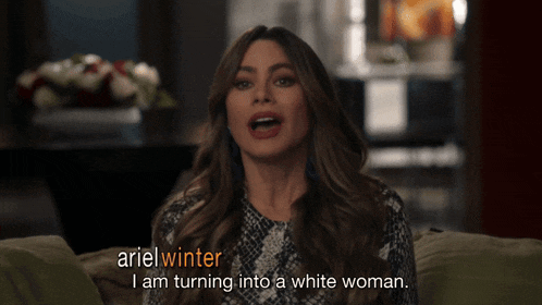 a woman is sitting on a couch and says ariel winter