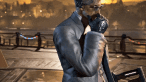 a man in a suit and glasses is standing on a dock