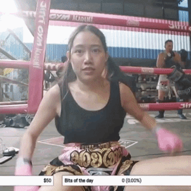 a woman in a boxing ring with bits of the day displayed