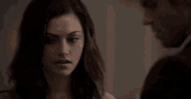a man and a woman are looking at each other .