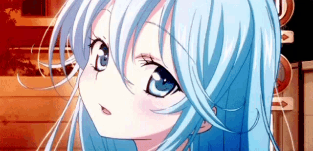 a close up of a girl with blue hair and blue eyes looking at the camera .