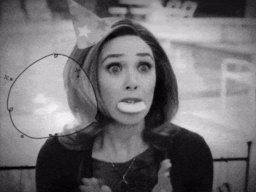 a woman wearing a party hat with stars on it