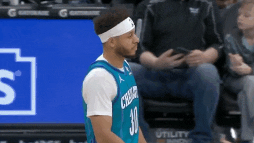 a basketball player wearing a headband that says charlotte on it