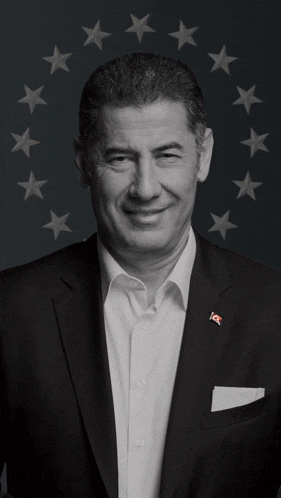 a black and white photo of a man in a suit with the letters ics on his pocket