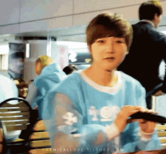 a boy in a blue shirt with the word ice on the sleeves