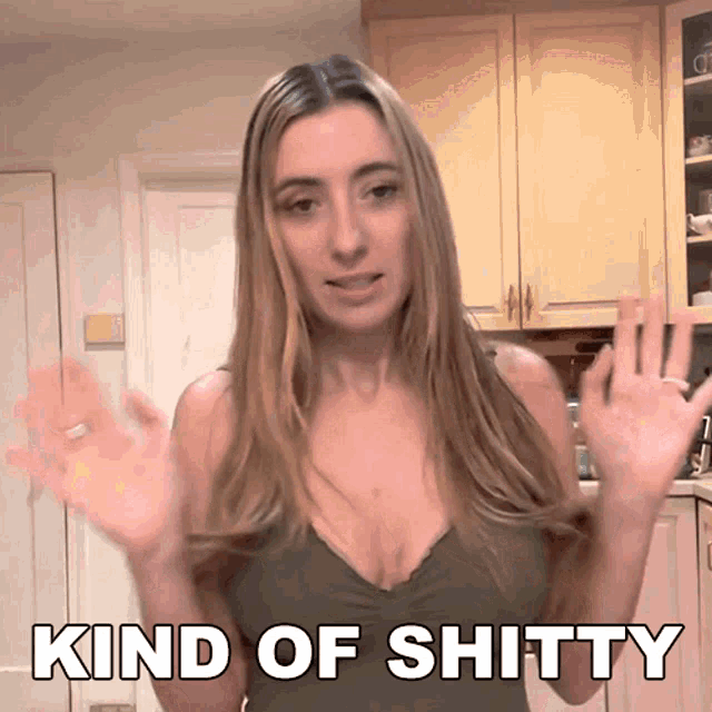 a woman in a kitchen with the words kind of shitty above her